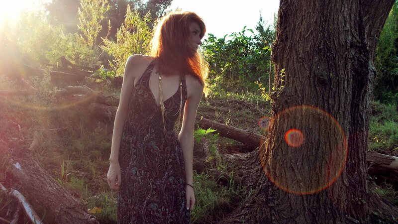 woman in forest at sunset