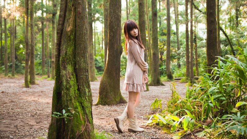 Woman in forest at sunset