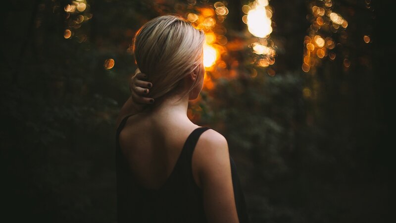 woman in forest at sunset