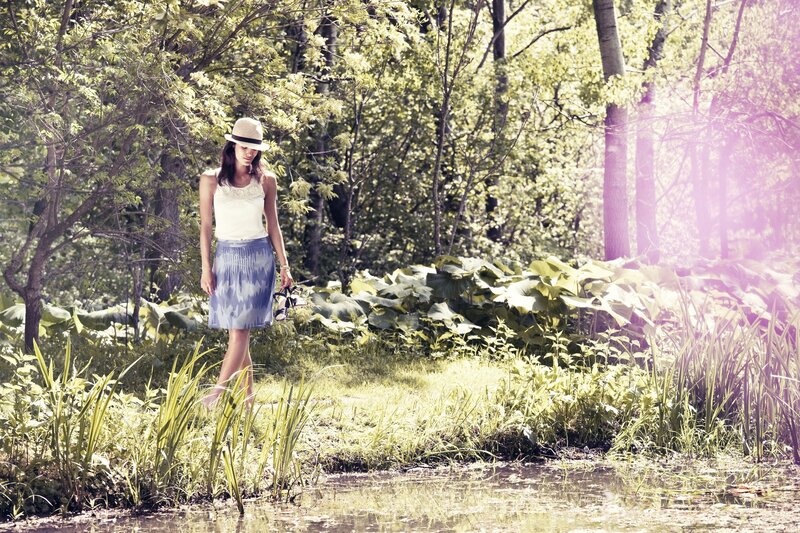 Woman in forest by pond
