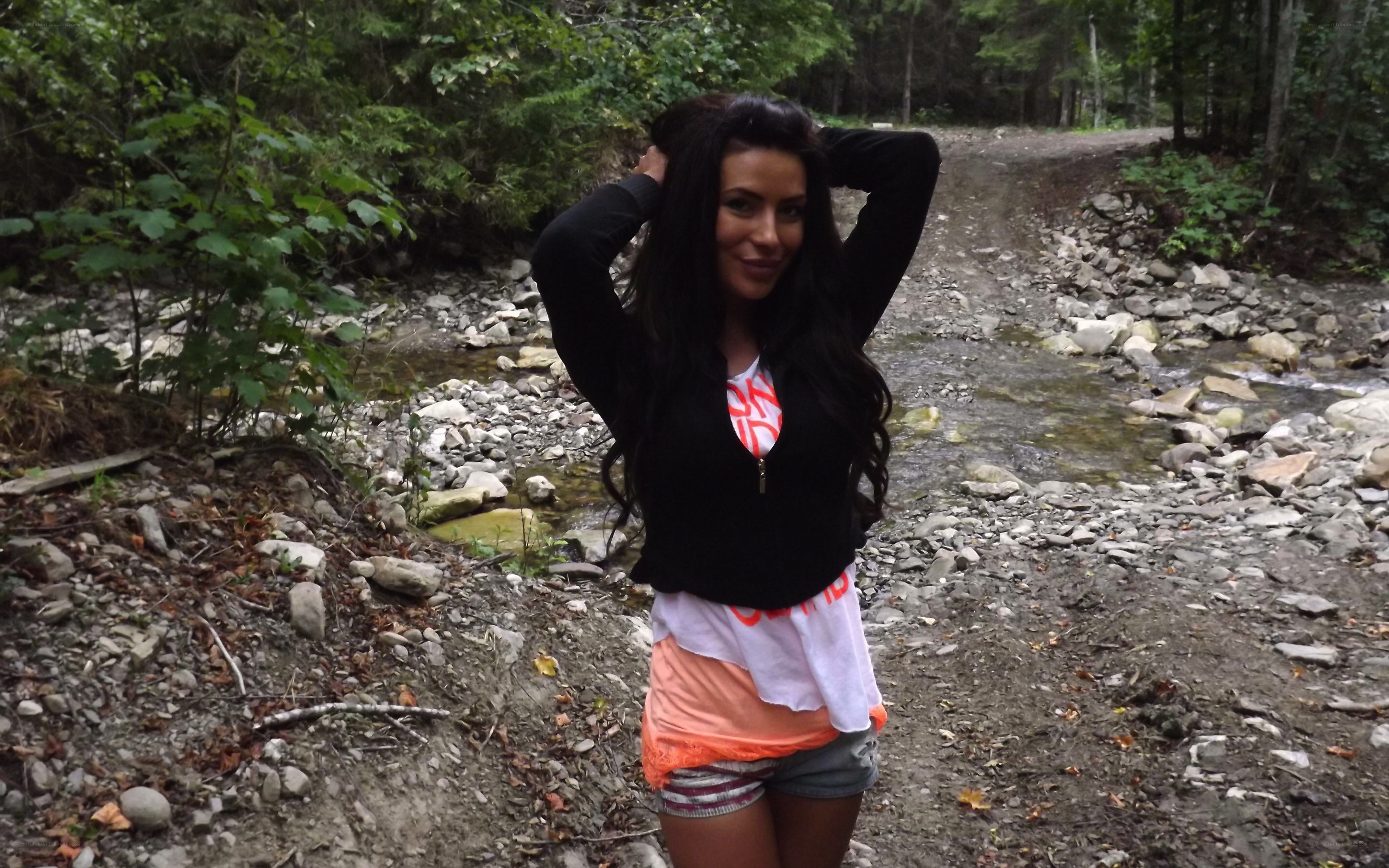 Woman in forest by stream