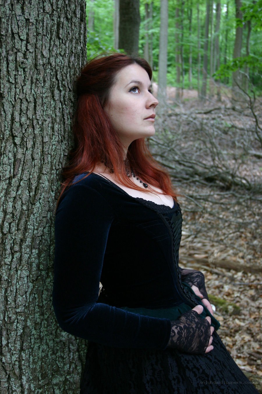 Woman in forest by tree