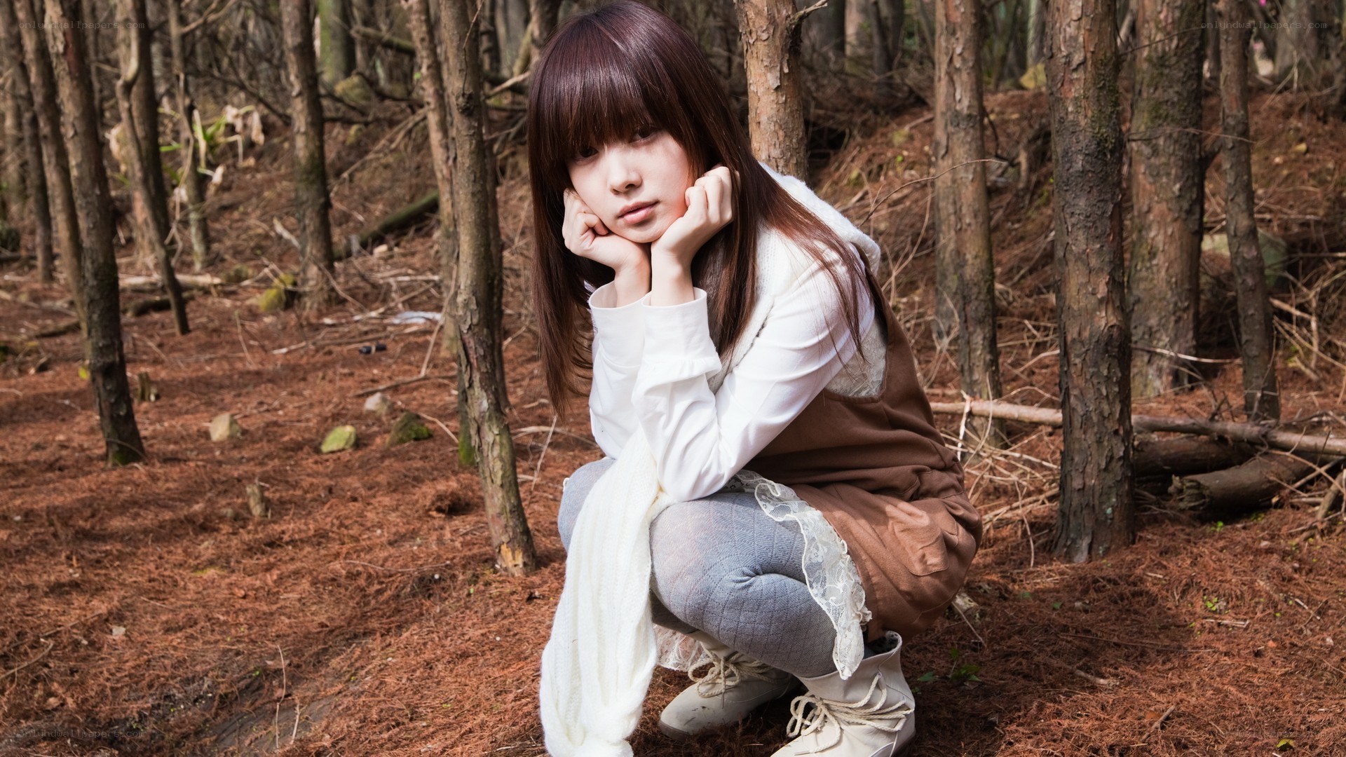 woman in forest crouching