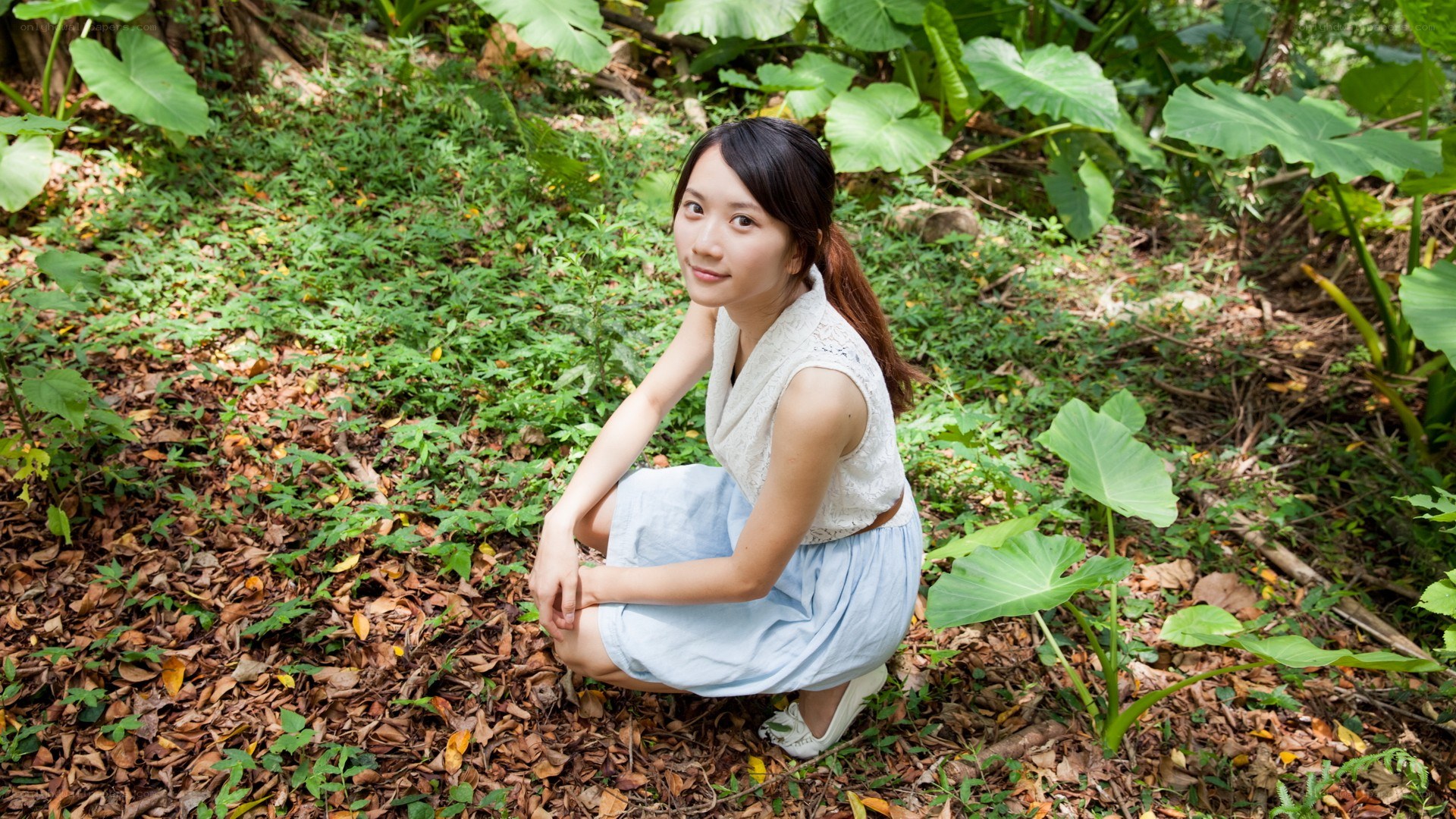 Woman in forest crouching
