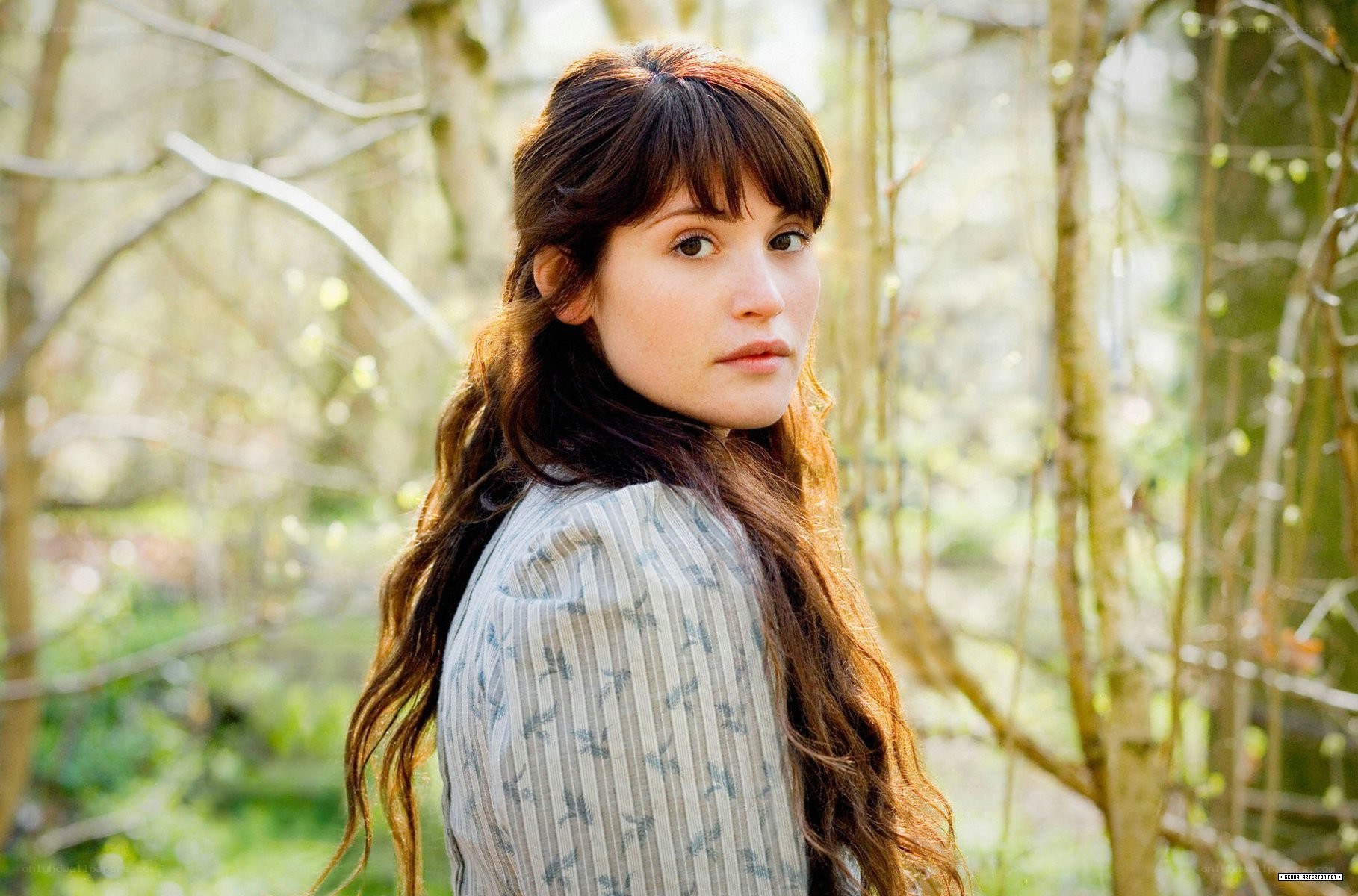 woman in forest looking back