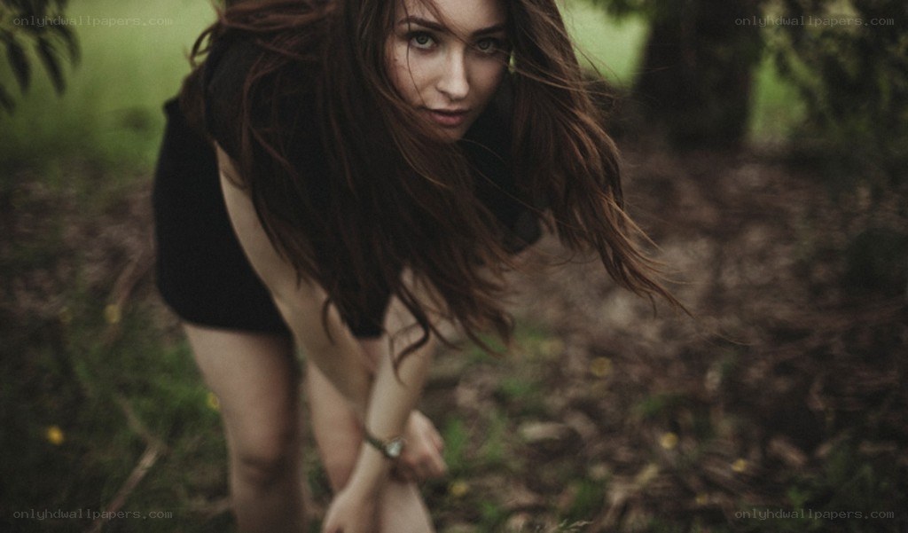 woman in forest looking down