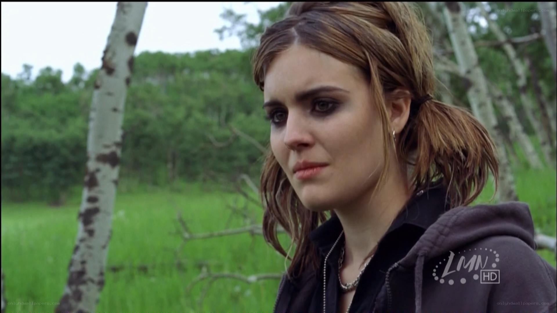 woman in forest looking sad