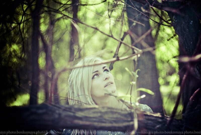woman in forest looking up