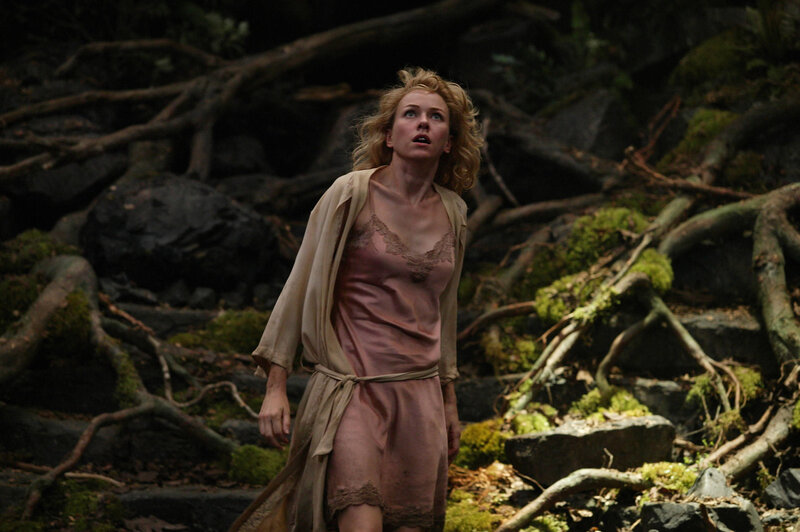 Woman in forest looking up