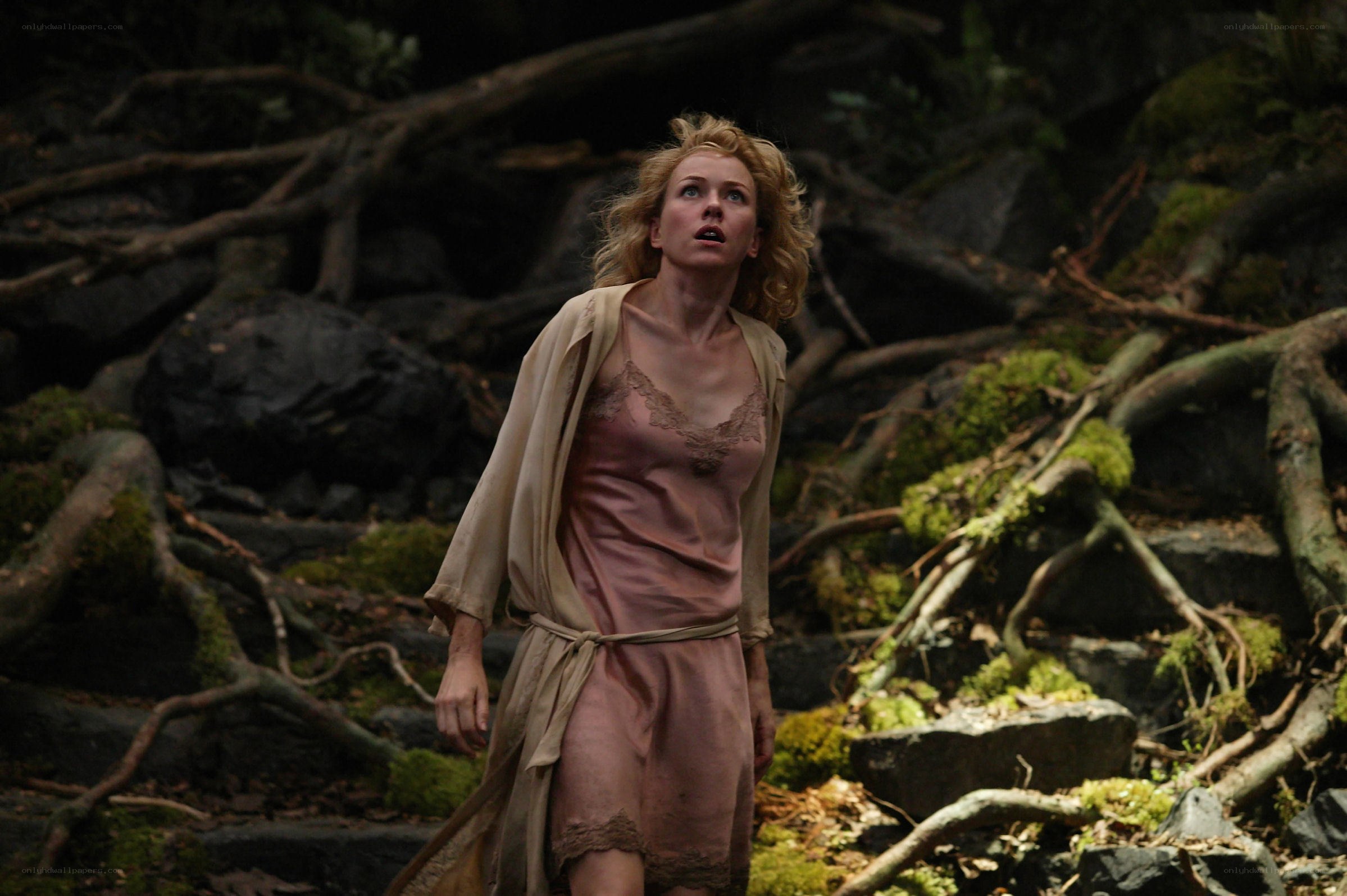 Woman in forest looking up