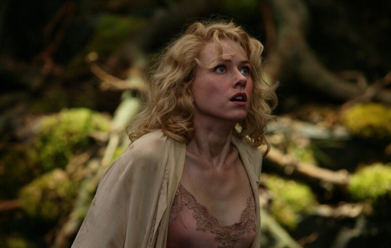 woman in forest looking up
