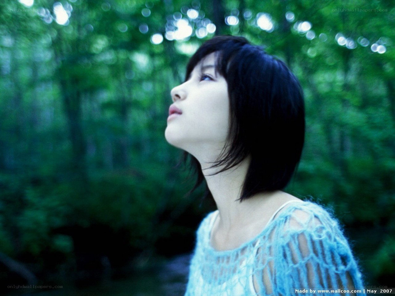 woman in forest looking up