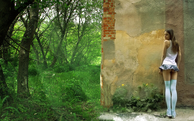 woman in forest near wall