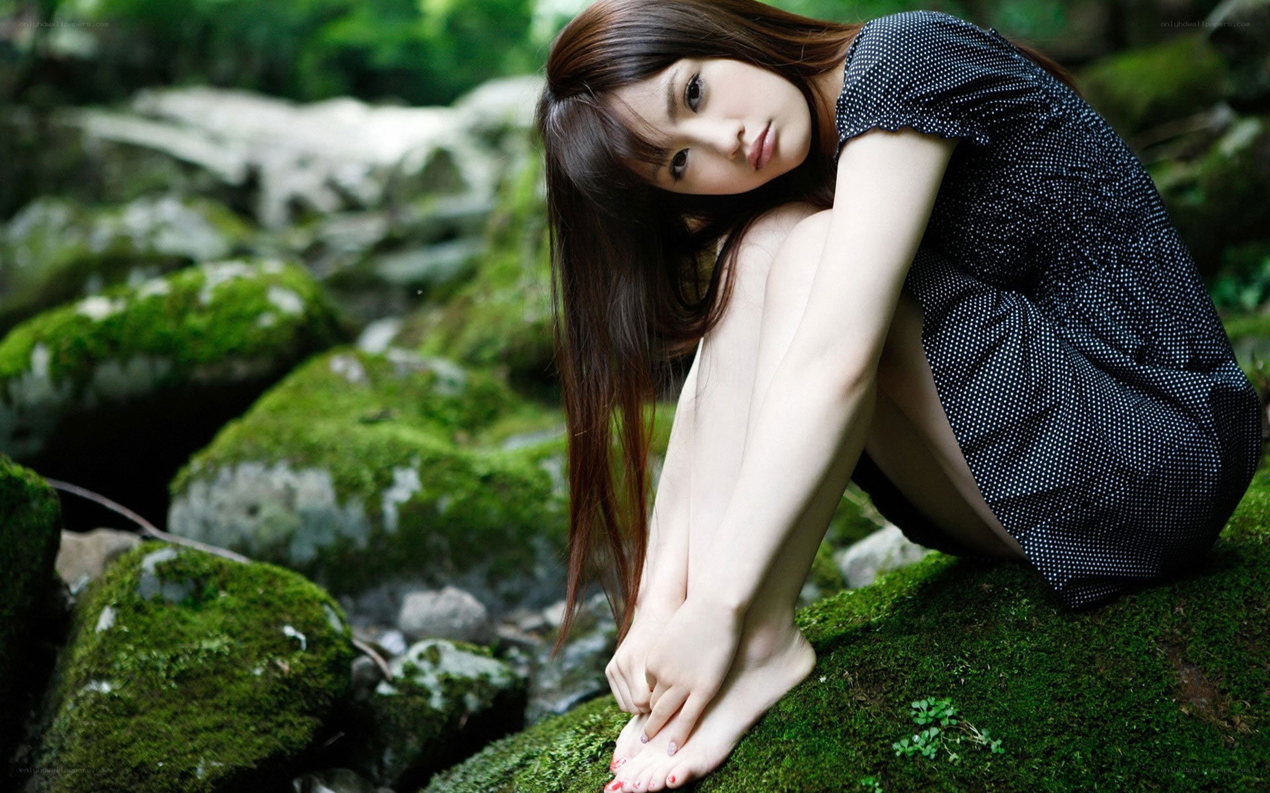 Woman in forest on moss
