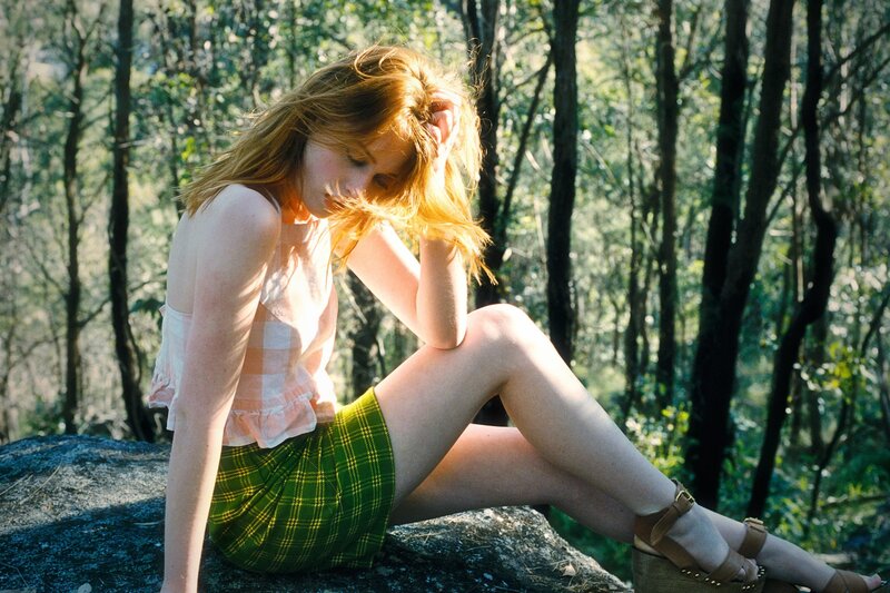 Woman in forest on rock