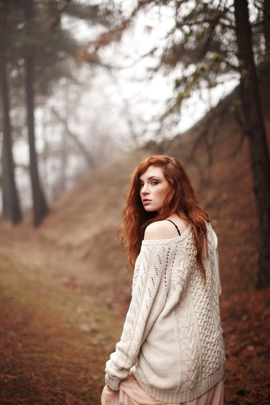 Woman in forest sweater