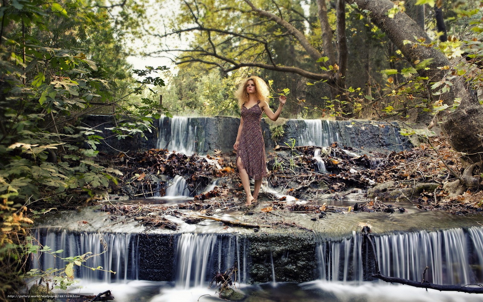 Woman in forest waterfall