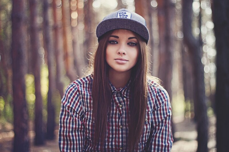 woman in forest wearing cap