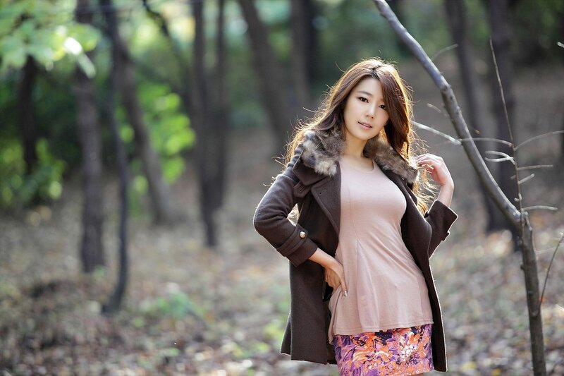 woman in forest wearing coat