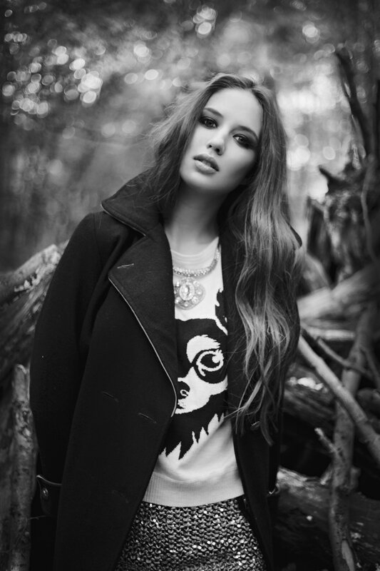 woman in forest wearing coat