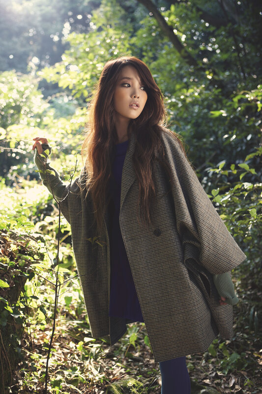 woman in forest wearing coat