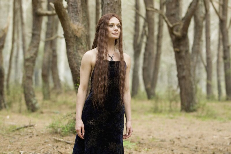 woman in forest wearing dark dress