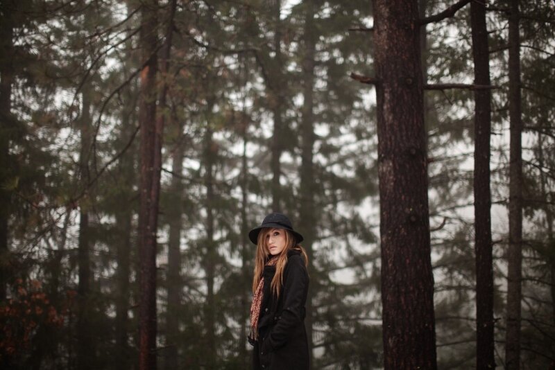 Woman in forest wearing hat