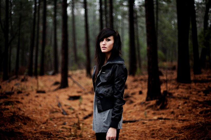 woman in forest wearing leather jacket