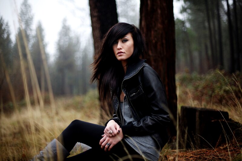woman in forest wearing leather jacket