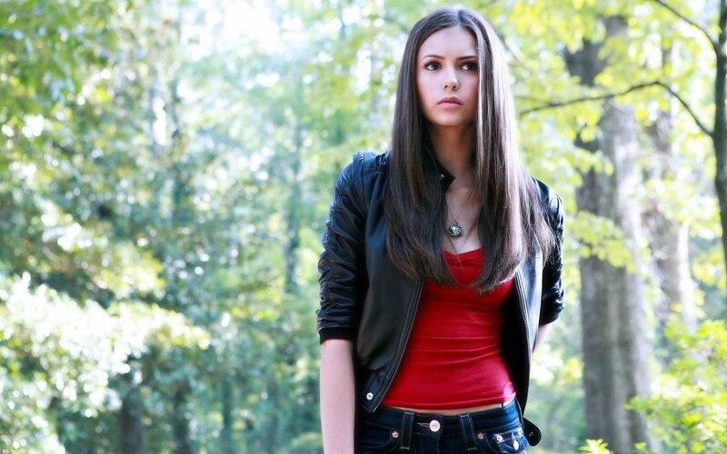woman in forest wearing leather jacket
