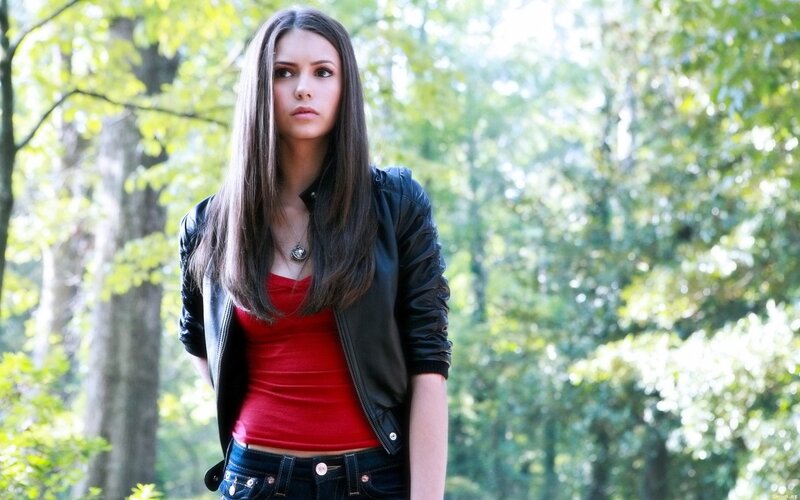 woman in forest wearing red top