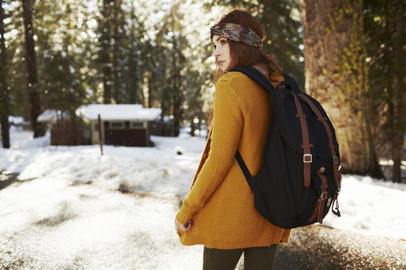 woman in forest with backpack