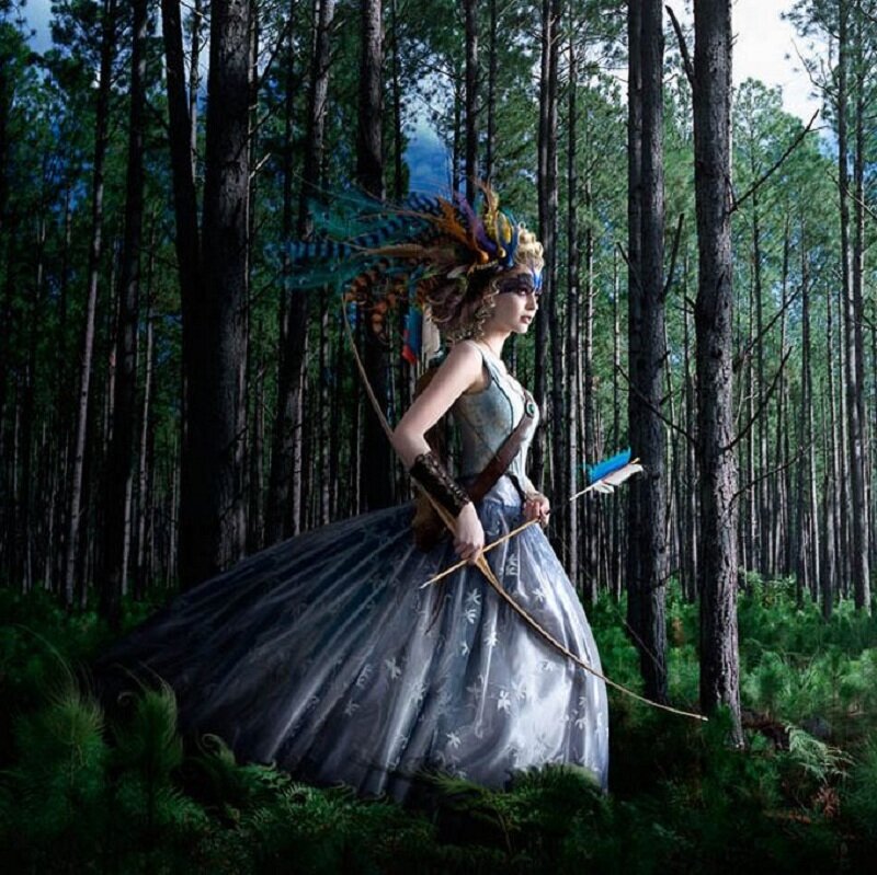 woman in forest with bow