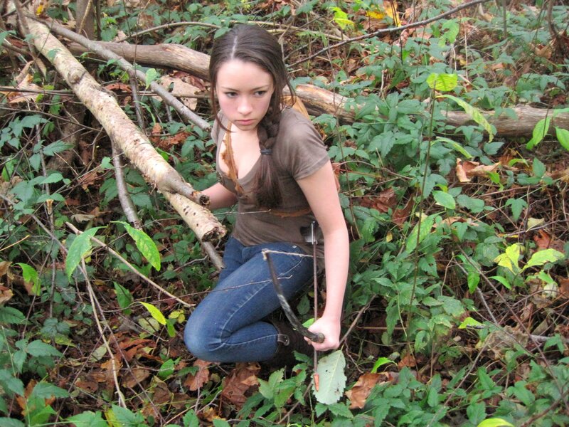 woman in forest with bow