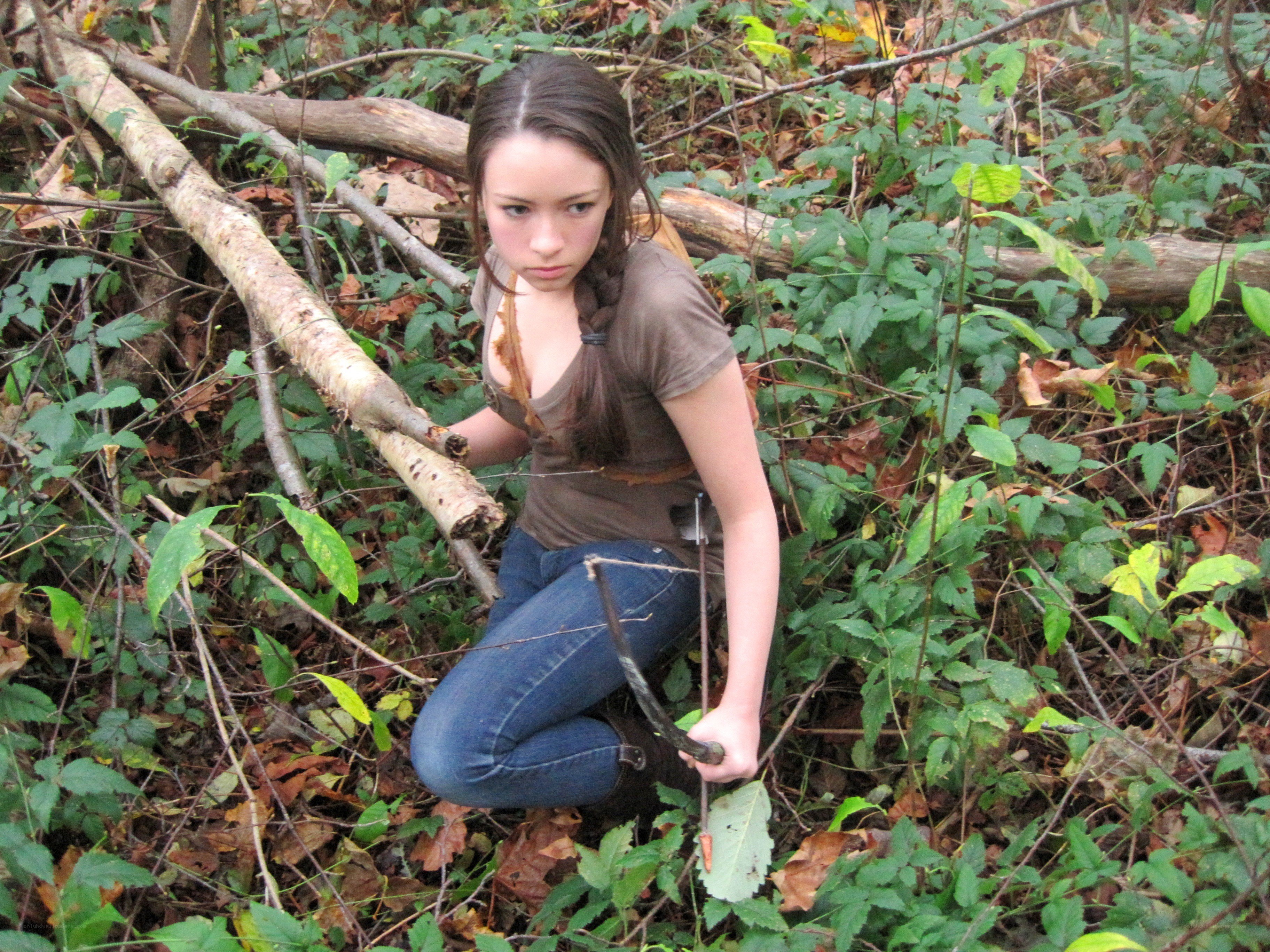 woman in forest with bow