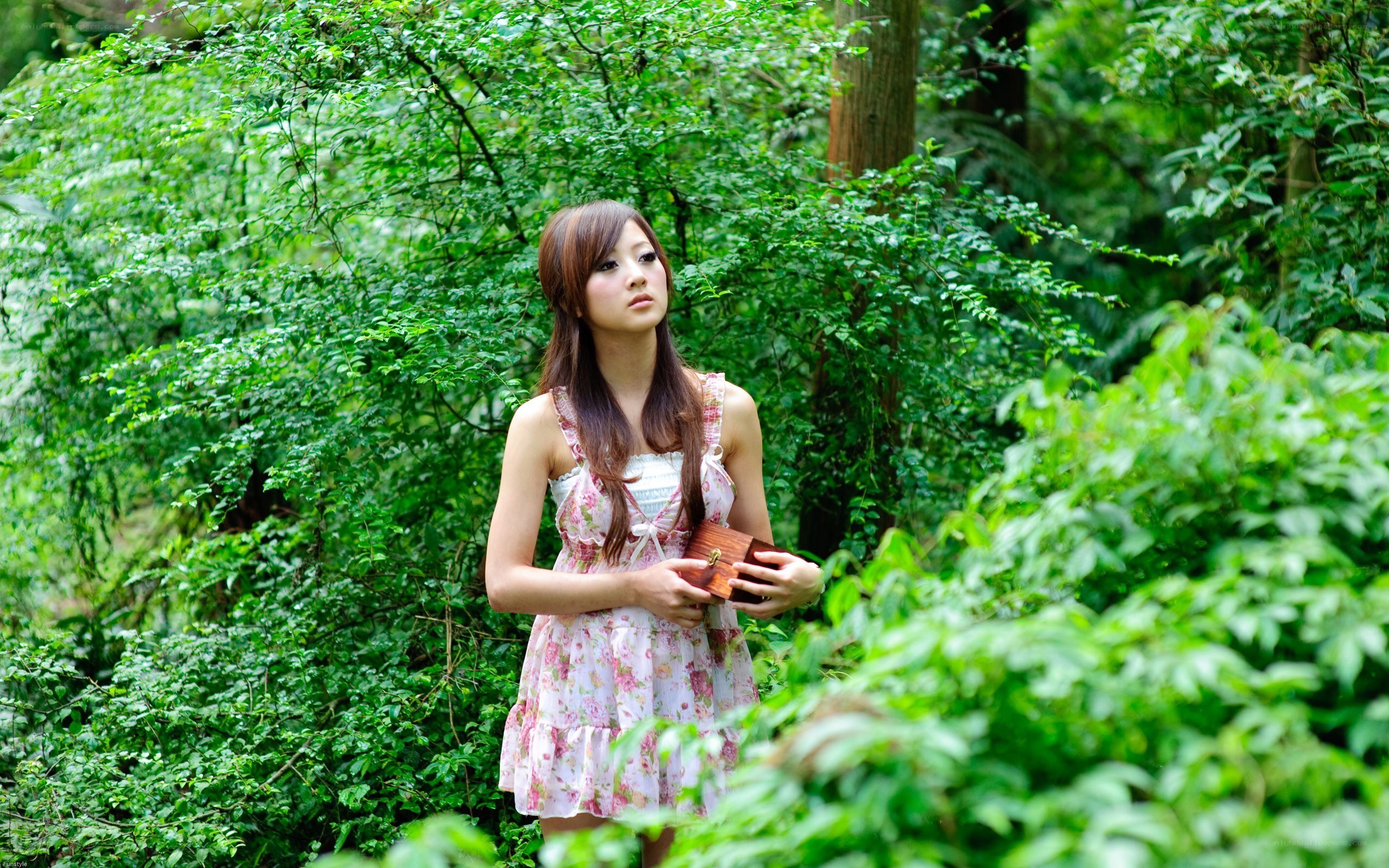 Woman in forest with box