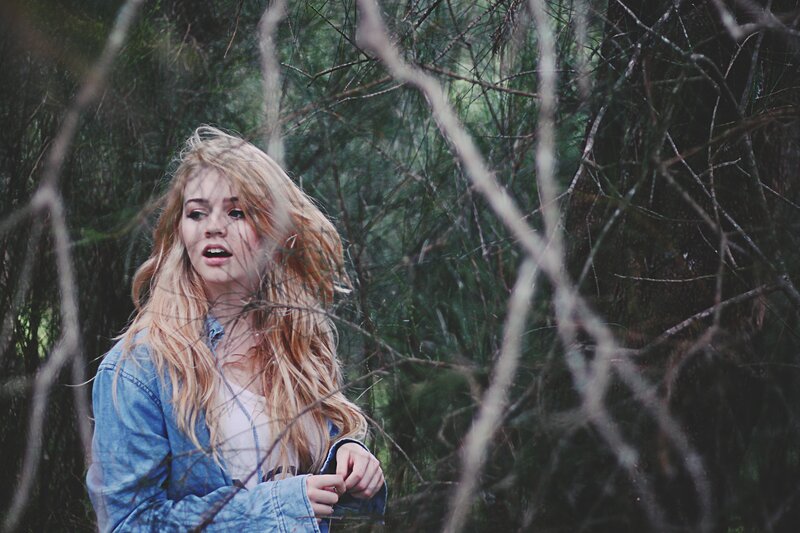 Woman in forest with branches