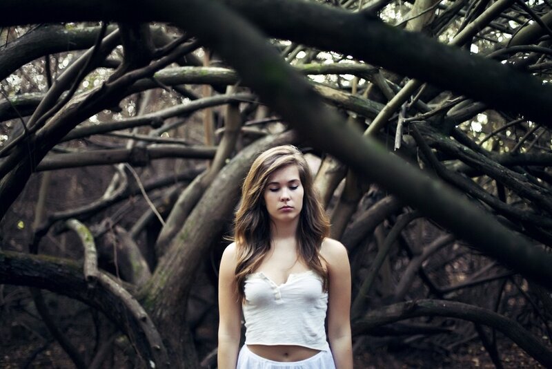 woman in forest with branches