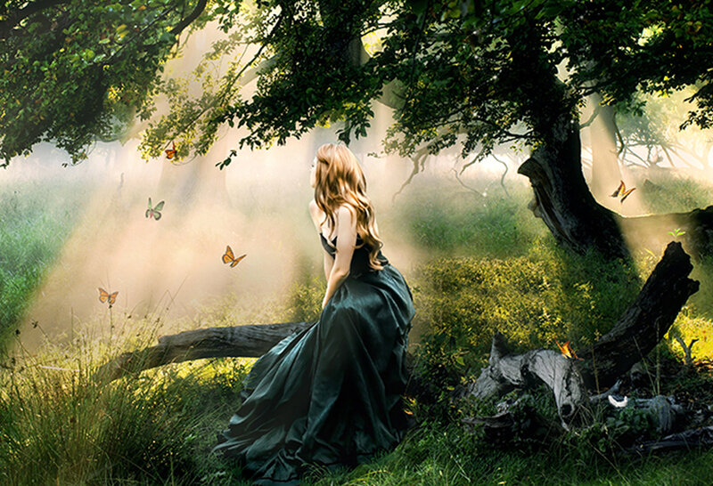 Woman in forest with butterflies