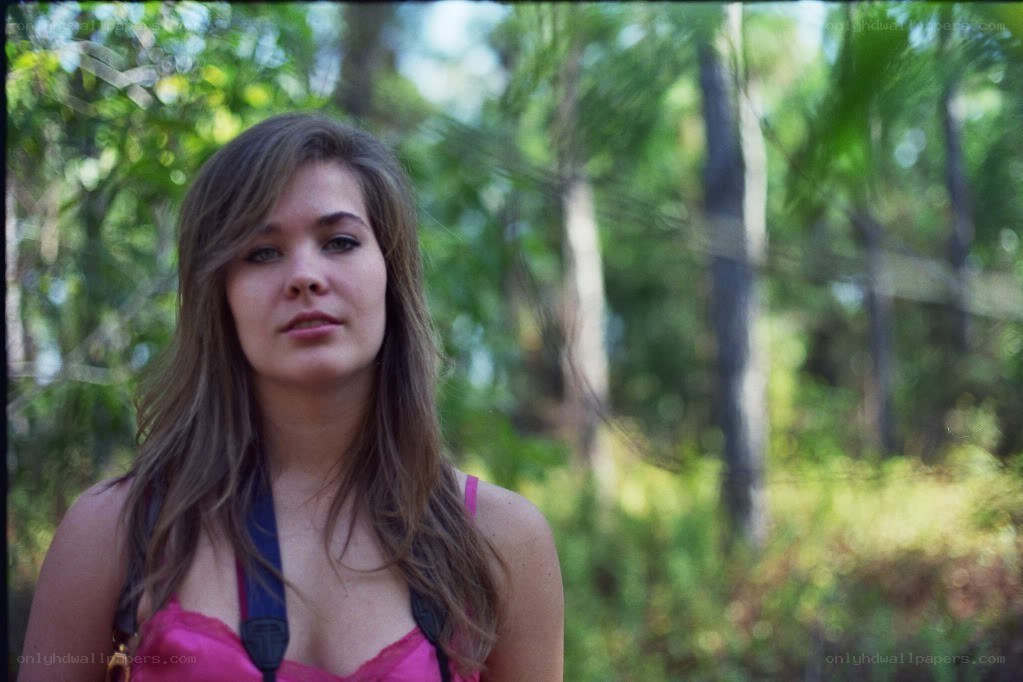 woman in forest with camera