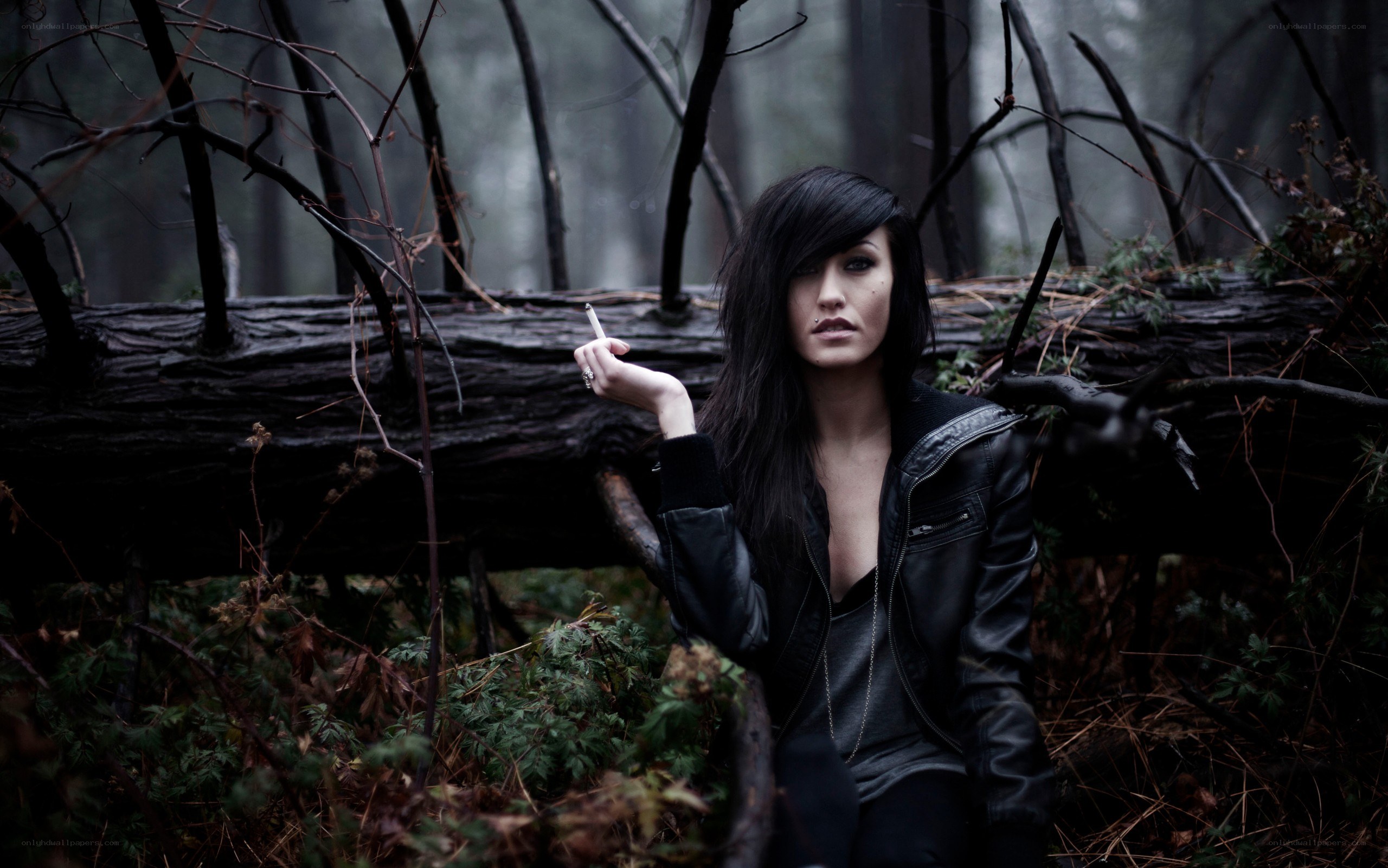 Woman in forest with cigarette