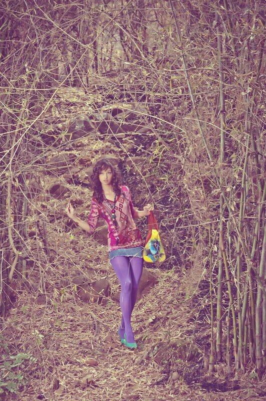 Woman in forest with colorful bag