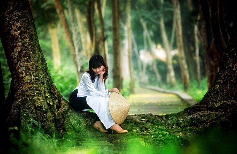 Woman in forest with conical hat