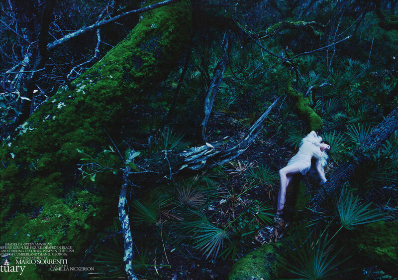 woman in forest with feathers