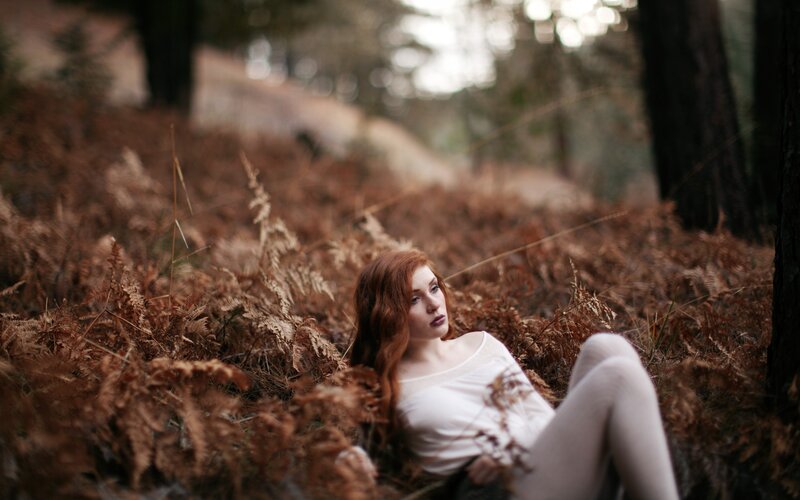 Woman in forest with ferns