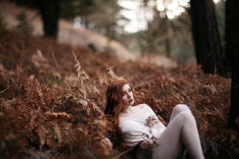 Woman in forest with ferns