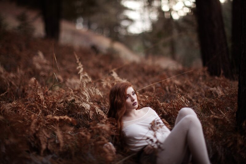 woman in forest with ferns