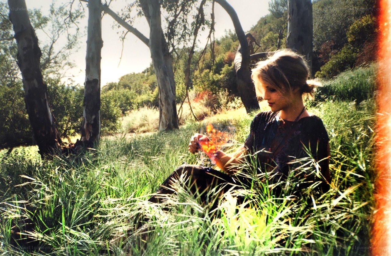 woman in forest with fire