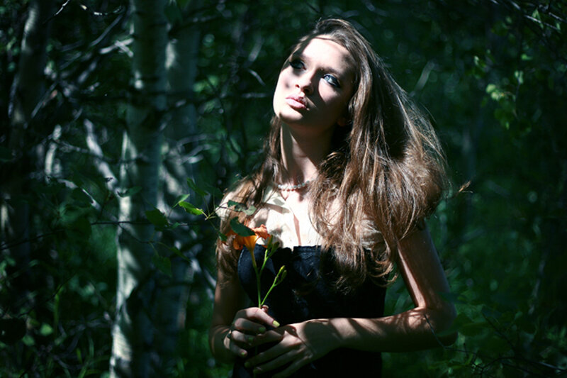 woman in forest with flower