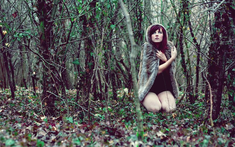 woman in forest with fur coat